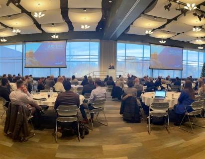 Photo from our Tech Strategy event, showing a room at Meijer Gardens full of people seated at numerous tables.